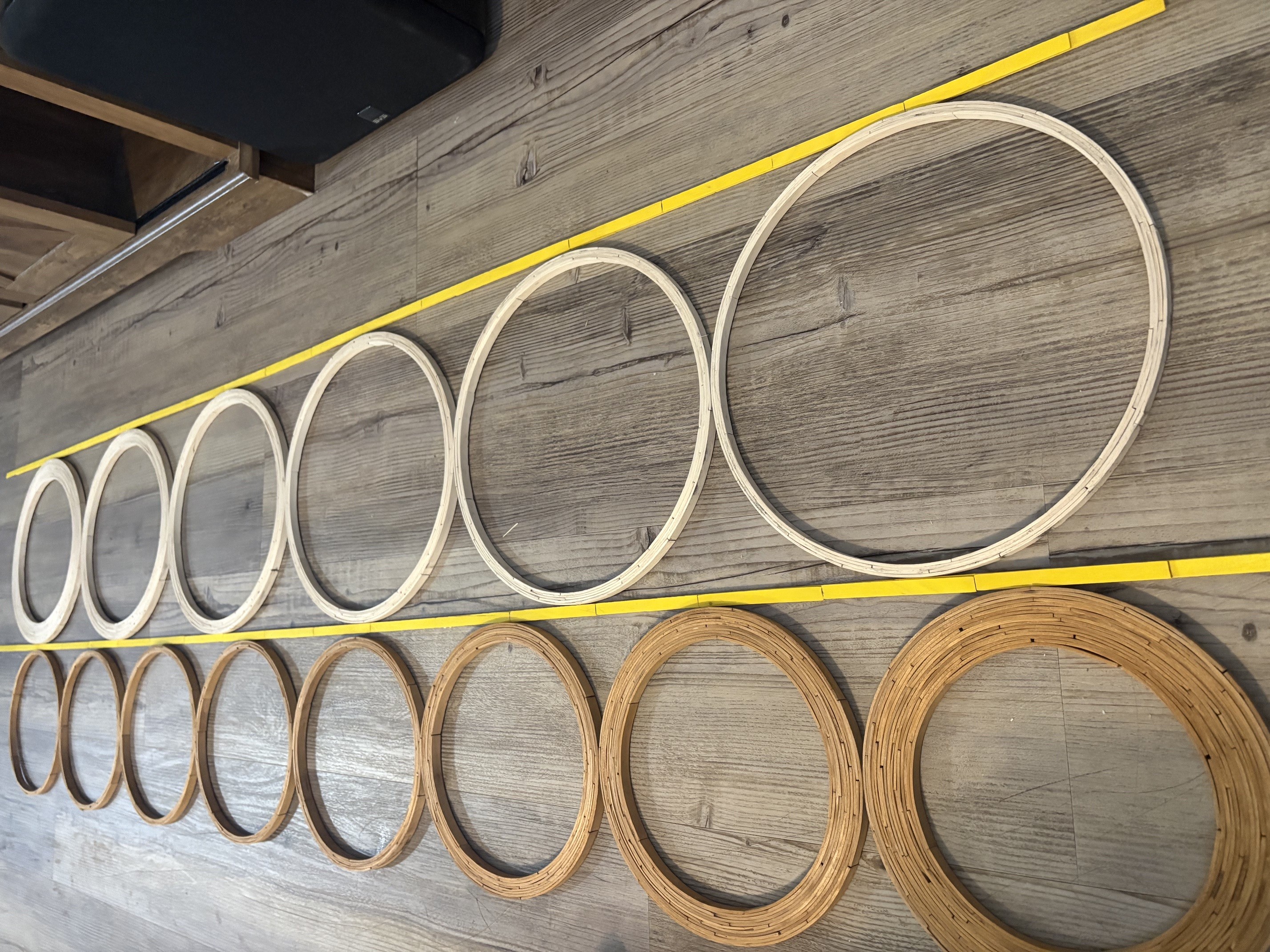Cluster of tall stacked-stick cylinders, one leaning against the others